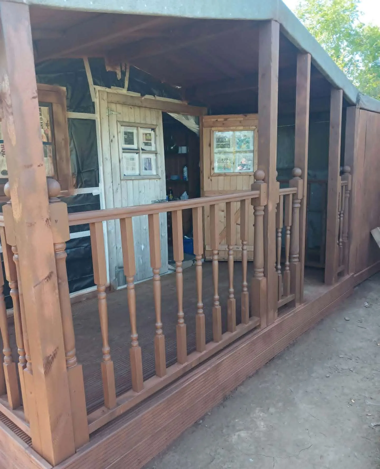 Timber garden studio with covered porch and turned balustrades