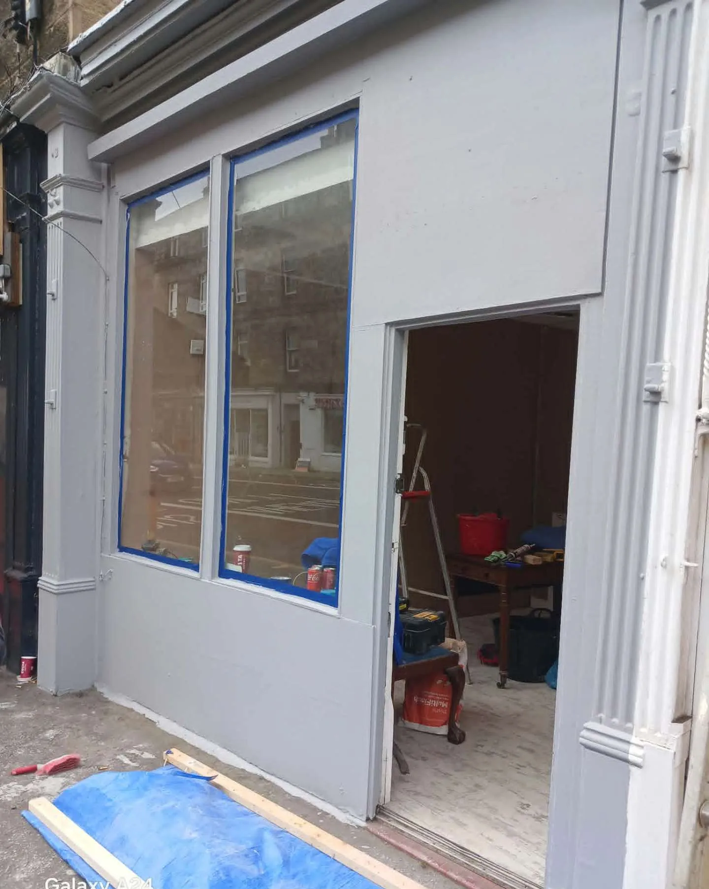 Edinburgh shopfront freshly repainted in soft grey with masked glazing