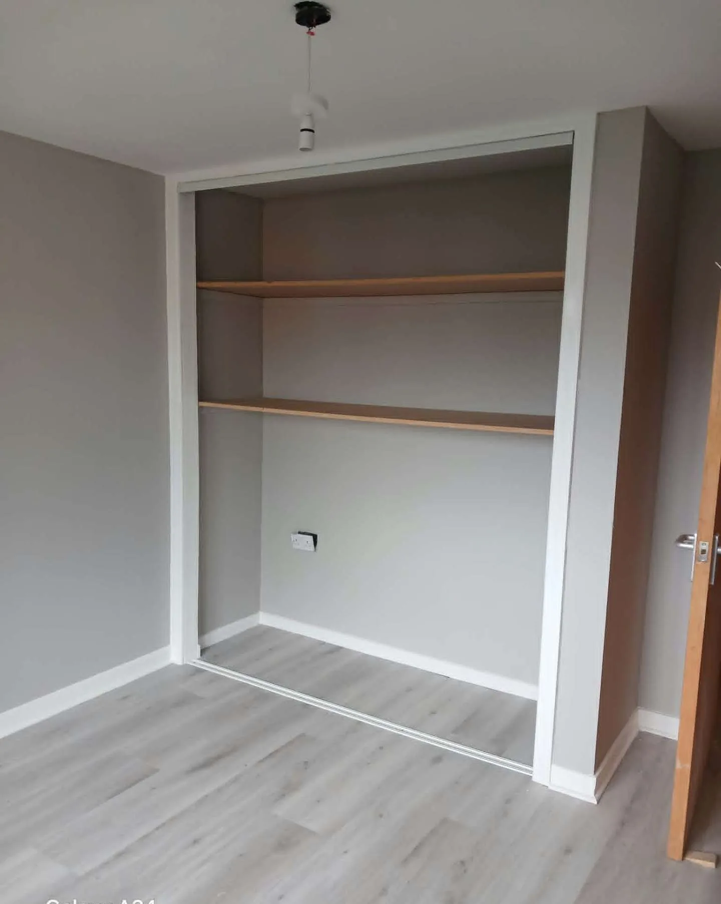 Alcove and shelving repainted in two-tone grey and white